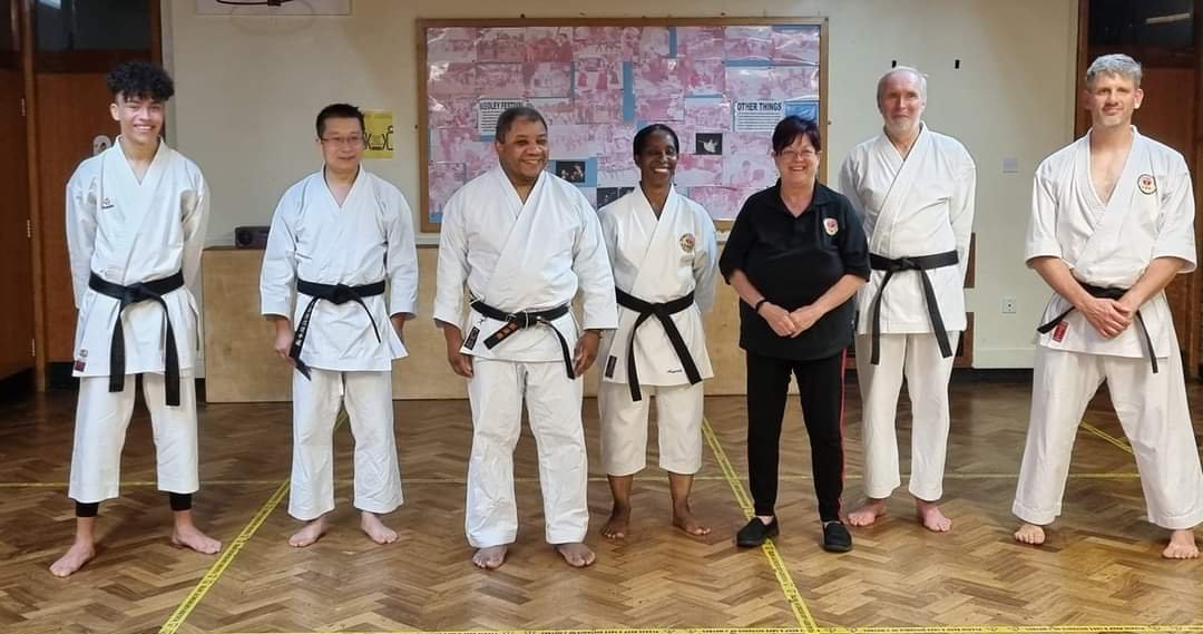 Black belts with their instructors after their grading