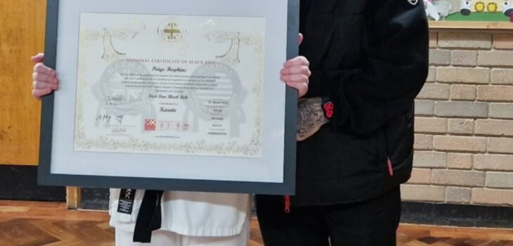 Paige and her dad Andrew with her framed certificate