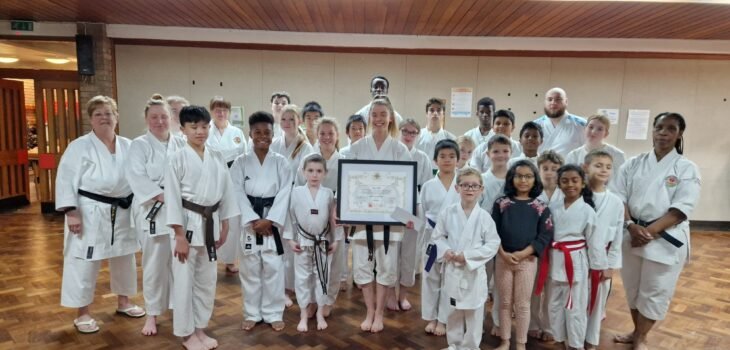 May group photo with framed certificate